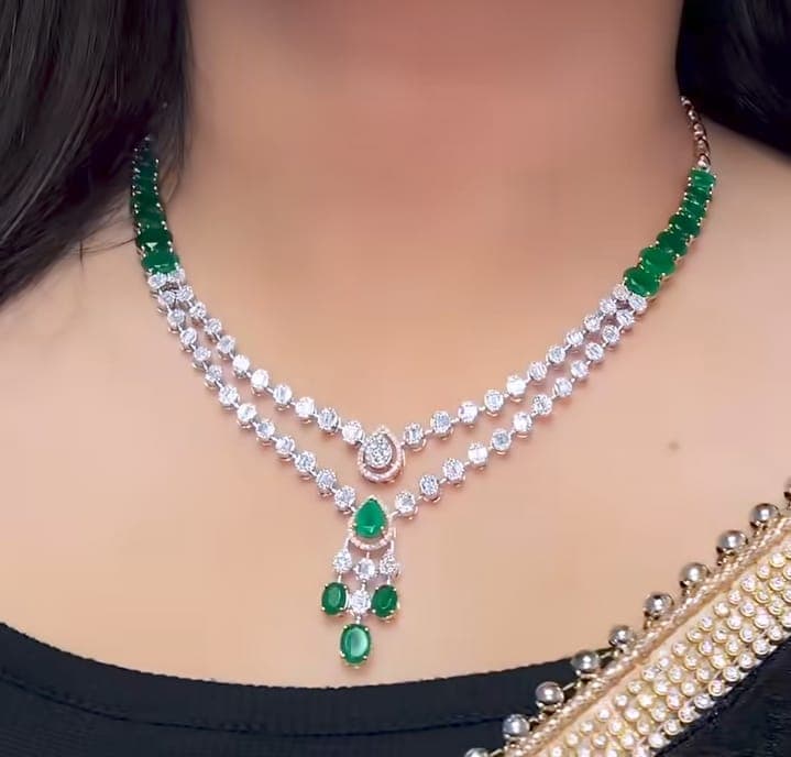 Chawla Jewellers Nisha emerald strand necklace — dual diamond lines with cascading pear and oval emerald pendant cluster