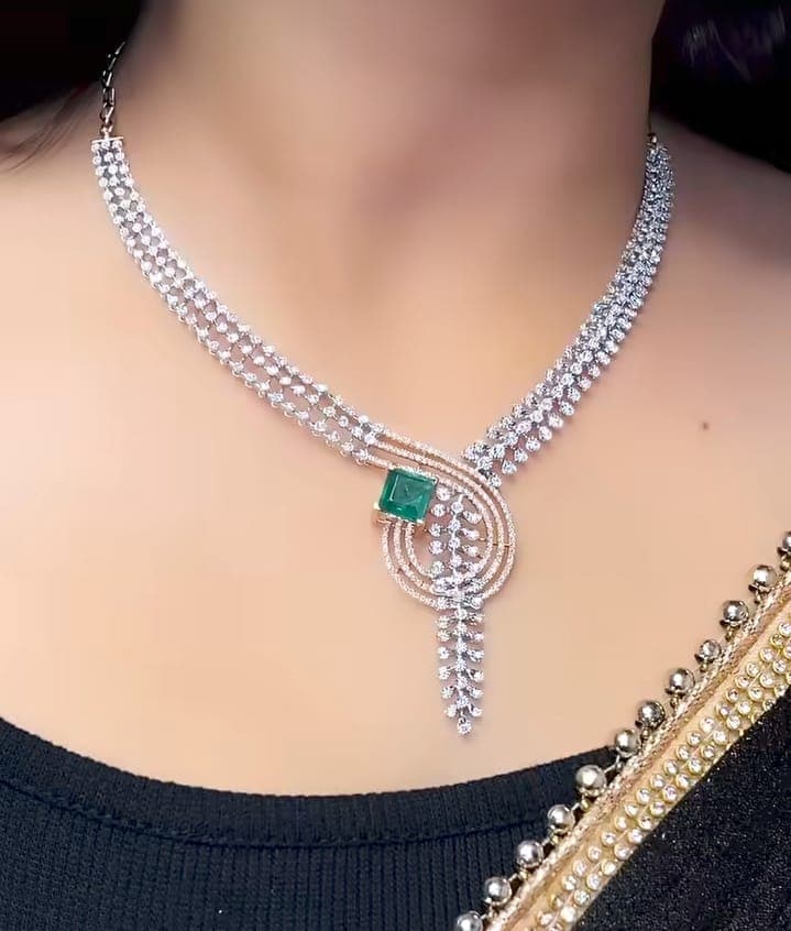 Chawla Jewellers Riya swirl emerald necklace — triple diamond strands with rose-gold pavé swirl and square emerald centre